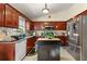 Well-equipped kitchen featuring dark cabinetry, stainless steel appliances, and a functional island for meal preparation at 120 Aspen Forest Dr, Covington, GA 30016