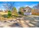 Home featuring a driveway leading to a two-car garage and a spacious backyard, perfect for outdoor activities at 120 Aspen Forest Dr, Covington, GA 30016