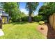 Lush backyard featuring a well-maintained lawn, mature trees, and manicured landscaping at 259 Sisson Ne Ave, Atlanta, GA 30317