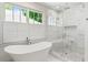 Bright bathroom featuring a soaking tub and a modern glass shower at 259 Sisson Ne Ave, Atlanta, GA 30317