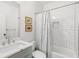 Bright bathroom featuring a white tiled shower/tub combo and a vanity with a modern sink at 259 Sisson Ne Ave, Atlanta, GA 30317