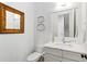 Elegant powder room with a framed mirror, stylish light fixture, and modern vanity with white countertop at 259 Sisson Ne Ave, Atlanta, GA 30317