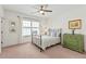 Cozy bedroom with iron bed frame, wood dresser, carpet, and natural light from a window at 259 Sisson Ne Ave, Atlanta, GA 30317