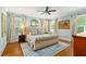 Beautiful bedroom with hardwood floors, a tufted bed, and multiple windows at 259 Sisson Ne Ave, Atlanta, GA 30317