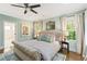 Comfortable bedroom with tufted headboard, hardwood floors, and bright natural light at 259 Sisson Ne Ave, Atlanta, GA 30317
