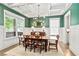 Elegant dining room with coffered ceilings, dark green walls, wainscoting and traditional furniture at 259 Sisson Ne Ave, Atlanta, GA 30317