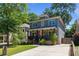 Beautiful two-story home with a spacious driveway, a manicured lawn and a covered front porch with ceiling fans at 259 Sisson Ne Ave, Atlanta, GA 30317