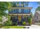 Charming two-story home featuring a welcoming porch with an American flag and a well-manicured front yard at 259 Sisson Ne Ave, Atlanta, GA 30317