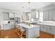 Well-appointed kitchen featuring stainless steel appliances, a large island with seating, and stylish light fixtures at 259 Sisson Ne Ave, Atlanta, GA 30317