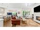 Open-concept living room showcasing a fireplace, built-in shelving, and views into the dining and kitchen areas at 259 Sisson Ne Ave, Atlanta, GA 30317