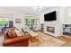 Bright living room featuring a fireplace with a marble surround, built-in shelves, and large windows at 259 Sisson Ne Ave, Atlanta, GA 30317