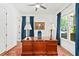Bright office space features hardwood floors, large windows with blue curtains, and a spacious wooden desk at 259 Sisson Ne Ave, Atlanta, GA 30317