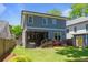 Rear exterior featuring a screened porch and a well-manicured lawn at 259 Sisson Ne Ave, Atlanta, GA 30317