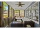 Inviting screened porch with comfortable seating, ceiling fan, and backyard views at 259 Sisson Ne Ave, Atlanta, GA 30317