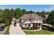 Aerial view of a beautiful home with mature trees, a spacious yard, and a long driveway at 3735 Duckcove Way, Cumming, GA 30041