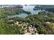 Panoramic aerial shot of homes near a lake surrounded by lush forests at 3735 Duckcove Way, Cumming, GA 30041