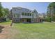 Expansive backyard view with stone and siding exterior and a covered patio at 3735 Duckcove Way, Cumming, GA 30041