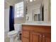 Bright bathroom with a wooden vanity, tiled floors, and a combination tub and shower at 3735 Duckcove Way, Cumming, GA 30041