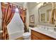 Bathroom features framed mirror and decoratively curtained shower at 3735 Duckcove Way, Cumming, GA 30041