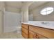 Modest bathroom showcasing a single sink vanity and a tub-shower combo under an oval window at 3735 Duckcove Way, Cumming, GA 30041