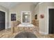 Bathroom featuring a bathtub with decorative tile surround and neutral paint, with a black door on either side at 3735 Duckcove Way, Cumming, GA 30041