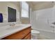 A bathroom features a wood vanity with a white countertop and a tub-shower with tile surround at 3735 Duckcove Way, Cumming, GA 30041