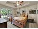 Cozy bedroom with tray ceilings, carpeted floors and a bright window view at 3735 Duckcove Way, Cumming, GA 30041