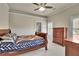 Cozy bedroom featuring neutral walls, a ceiling fan, and a comfortable bed with a decorative quilt at 3735 Duckcove Way, Cumming, GA 30041