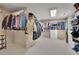 Spacious walk-in closet featuring organized shelving, hanging racks, and ample storage space for clothing at 3735 Duckcove Way, Cumming, GA 30041
