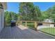 Wooden deck with green lush backyard in the background, and outdoor grill at 3735 Duckcove Way, Cumming, GA 30041