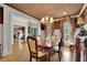 Dining room with hardwood floors, decorative curtains, chandelier lighting and direct view to the yard at 3735 Duckcove Way, Cumming, GA 30041