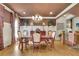 Elegant dining room featuring hardwood floors, chandelier lighting, and decorative wall paneling at 3735 Duckcove Way, Cumming, GA 30041