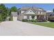 Stately home with a circular drive and manicured lawn at 3735 Duckcove Way, Cumming, GA 30041