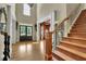 Entryway with wood staircase and grand front door at 3735 Duckcove Way, Cumming, GA 30041