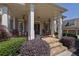 Charming front porch with stone flooring, rocking chairs, and manicured landscaping at 3735 Duckcove Way, Cumming, GA 30041