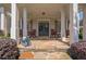 Inviting front porch with stone flooring, rocking chairs, and stately columns at 3735 Duckcove Way, Cumming, GA 30041