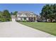 Beautiful two-story home featuring a long driveway, well-manicured lawn, and lovely landscaping at 3735 Duckcove Way, Cumming, GA 30041