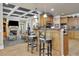 Stylish kitchen island with bar seating overlooks the open living area and stone fireplace at 3735 Duckcove Way, Cumming, GA 30041