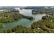 Scenic aerial view of a lake surrounded by lush greenery and waterfront homes at 3735 Duckcove Way, Cumming, GA 30041