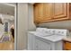 Laundry room featuring a washer and dryer with a connecting hallway at 3735 Duckcove Way, Cumming, GA 30041