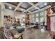 Spacious living room featuring tile floors, coffered ceilings, and ample natural light at 3735 Duckcove Way, Cumming, GA 30041