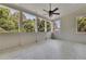 Relaxing sunroom with tiled floors, multiple windows, and a ceiling fan at 3735 Duckcove Way, Cumming, GA 30041