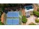 Aerial shot of pristine tennis courts and an in-ground pool with lounge chairs at 3735 Duckcove Way, Cumming, GA 30041