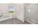 Bright bathroom with double sinks, soaking tub, separate glass shower, and large window at 5430 Flat Rock Pt, Stonecrest, GA 30038