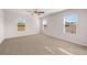 Bright bedroom with carpet floors, a ceiling fan, and three windows that provide natural light at 5430 Flat Rock Pt, Stonecrest, GA 30038