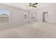 Spacious bedroom with carpet floors, a ceiling fan, and large windows that bring in plenty of natural light at 5430 Flat Rock Pt, Stonecrest, GA 30038