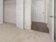 Bedroom view showing a closet with shelving and carpet floors at 5430 Flat Rock Pt, Stonecrest, GA 30038