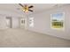 Large carpeted bedroom featuring a ceiling fan and large windows with natural light at 5430 Flat Rock Pt, Stonecrest, GA 30038
