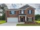 Charming brick two-story home with a welcoming entrance and a two-car garage at 5430 Flat Rock Pt, Stonecrest, GA 30038