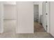 Hallway view showing a bathroom with tile floors and adjacent room with neutral carpeting at 5430 Flat Rock Pt, Stonecrest, GA 30038